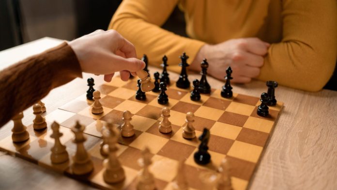Two people playing a game of chess