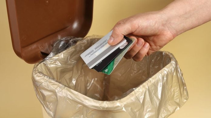 BetMGM-emerges-as-latest-US-operator-to-ban-credit-card-funding A person throwing credit cards into a trash can