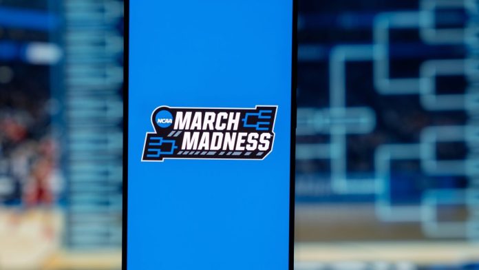 DraftKings-claims-fair-March-Madness-usage-after-NCAA-sues The trademarked March Madness phrase and logo on a phone screen