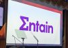 The Entain logo on a screen at an SBC Awards ceremony