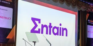 The Entain logo on a screen at an SBC Awards ceremony
