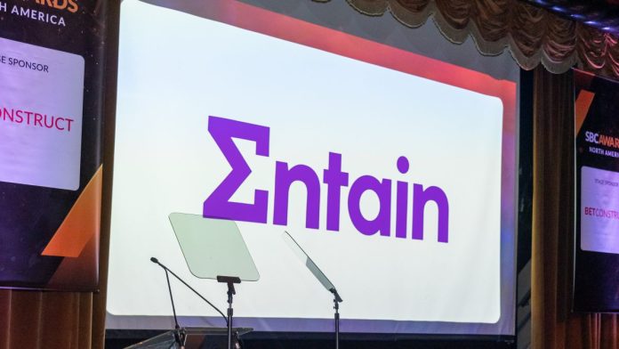 The Entain logo on a screen at an SBC Awards ceremony
