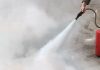 A person using a fire extinguisher