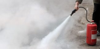 A person using a fire extinguisher