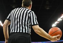 A basketball referee holding a ball