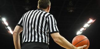 A basketball referee holding a ball