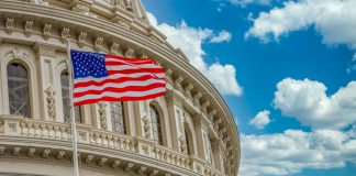The US flag flying in front of Congress