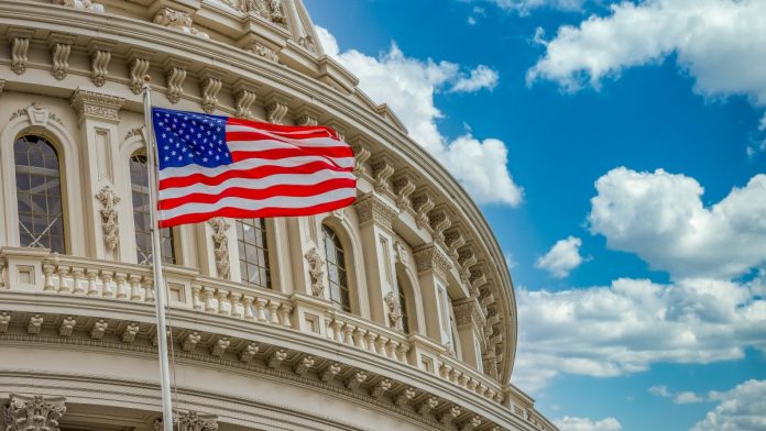 Prediction-Markets-Weekly-Federal-spotlight-burns-Kalshi-goes-crazy-for-Madness The US flag flying in front of Congress