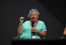Sue Schneider speaking on stage
