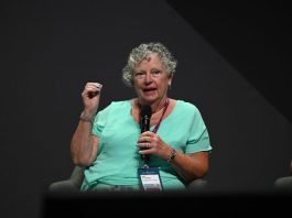 Sue Schneider speaking on stage
