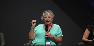 Sue Schneider speaking on stage