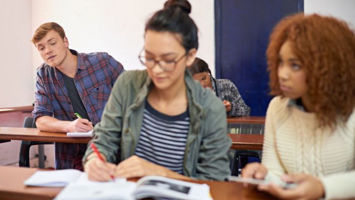 Vermont-latest-state-looking-to-copy-Illinois'-per-wager-tax A student copying another student's work during a test