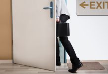A person walking out of an exit door