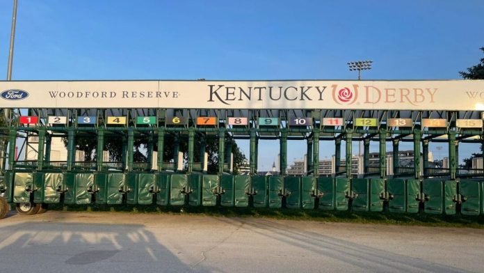 The starting gate for the Kentucky Derby stands ready on the track at Churchill Downs.