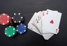 Poker chips next to a deck of cards
