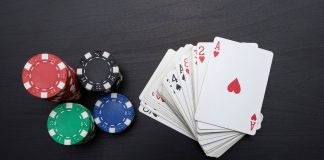 Poker chips next to a deck of cards