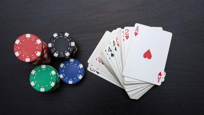 FanDuels-integrated-PokerStars-launches-in-3-states Poker chips next to a deck of cards