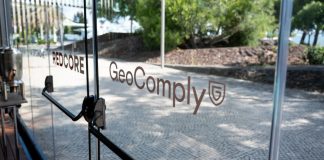 An exit door with GeoComply's branding on it