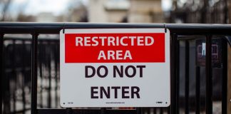 A 'restricted area' sign on a fence