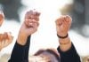 As CFTC outlines sports prediction markets rules, states and tribes take action People with arms raised in protest