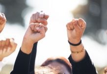 People with arms raised in protest