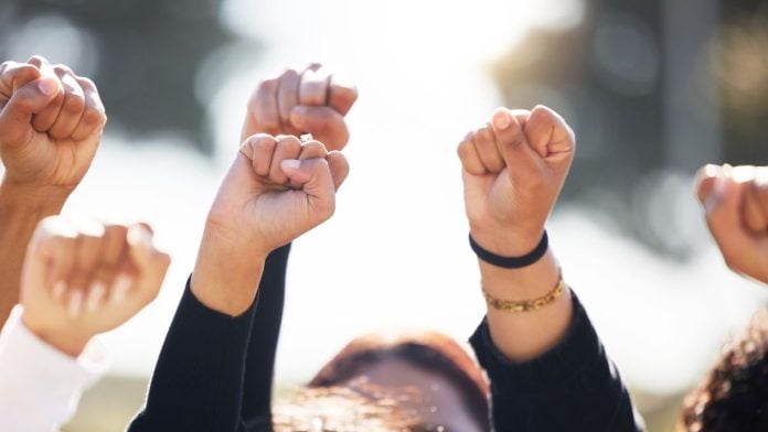 After-CFTC-outlines-its-sports-stance-states-and-tribes-take-up-arms People with arms raised in protest