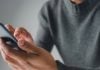 Person on cellphone as Colorado bans sportsbooks from sending push notifications.