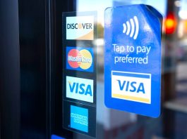 Florida tells payment giants: Stop working with illegal gambling sites Signs for Visa, Mastercard, and American Express on a shop door