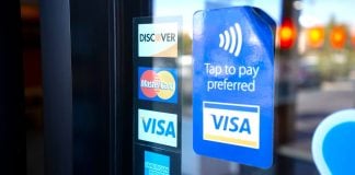 Florida tells payment giants: Stop working with illegal gambling sites Signs for Visa, Mastercard, and American Express on a shop door