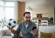 A person watching live sports as New Jersey advances a micro bet ban.