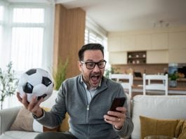 A person watching live sports as New Jersey advances a micro bet ban.