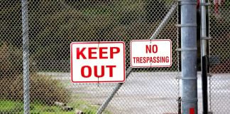 A 'Keep Out' sign on a fence
