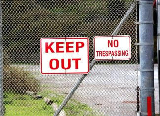 A 'Keep Out' sign on a fence