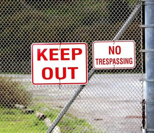 A 'Keep Out' sign on a fence