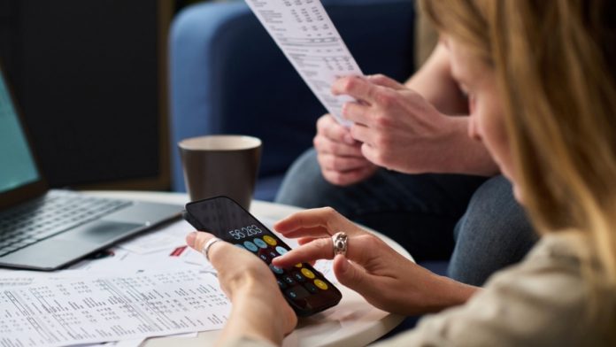 New-York-Monthly-Statement-Bill A person looking at statements as NY advances a consumer protection gambling bill.