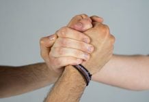 Three people joining hands