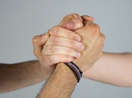 Three people joining hands