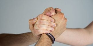 Three people joining hands
