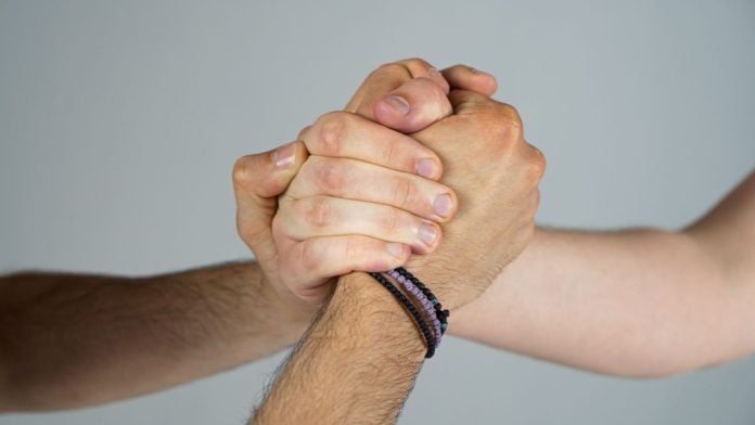 Prediction-market-giants-unite-to-sue-Kentucky-over-planned-tax Three people joining hands