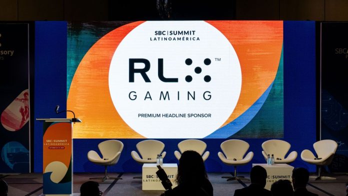 RLX-Gaming-names-ReelPlay-first-partner-for-US-online-casino-aggregation-platform The RLX Gaming logo at an SBC event