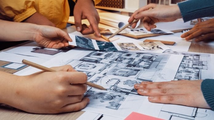 People looking at a blueprint sketch