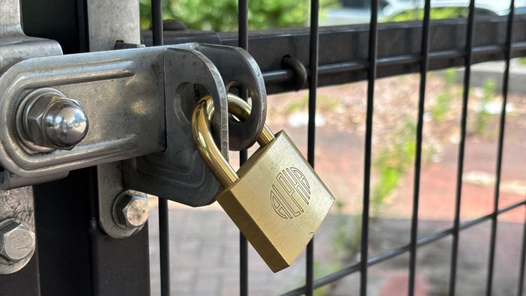 A padlock on a fence