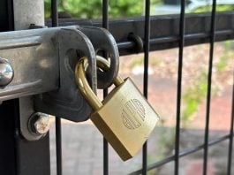 A padlock on a fence