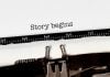 Vintage typewriter on white background with text "story begins"