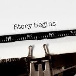 Vintage typewriter on white background with text "story begins"