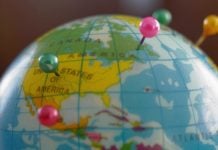 A globe with pins as GeoComply and FanDuel renew their partnership.