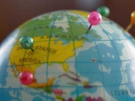 A globe with pins as GeoComply and FanDuel renew their partnership.