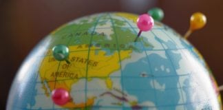 A globe with pins as GeoComply and FanDuel renew their partnership.