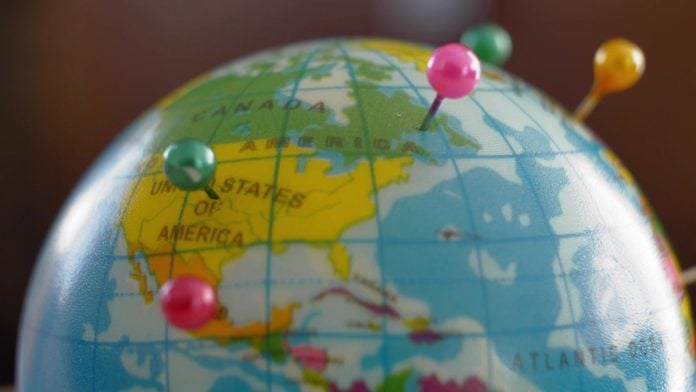 FanDuel-GeoComply-Renew-Deal A globe with pins as GeoComply and FanDuel renew their partnership.