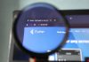 Will FanDuel Predicts catch up to prediction markets rivals? The Flutter logo through a magnifying glass
